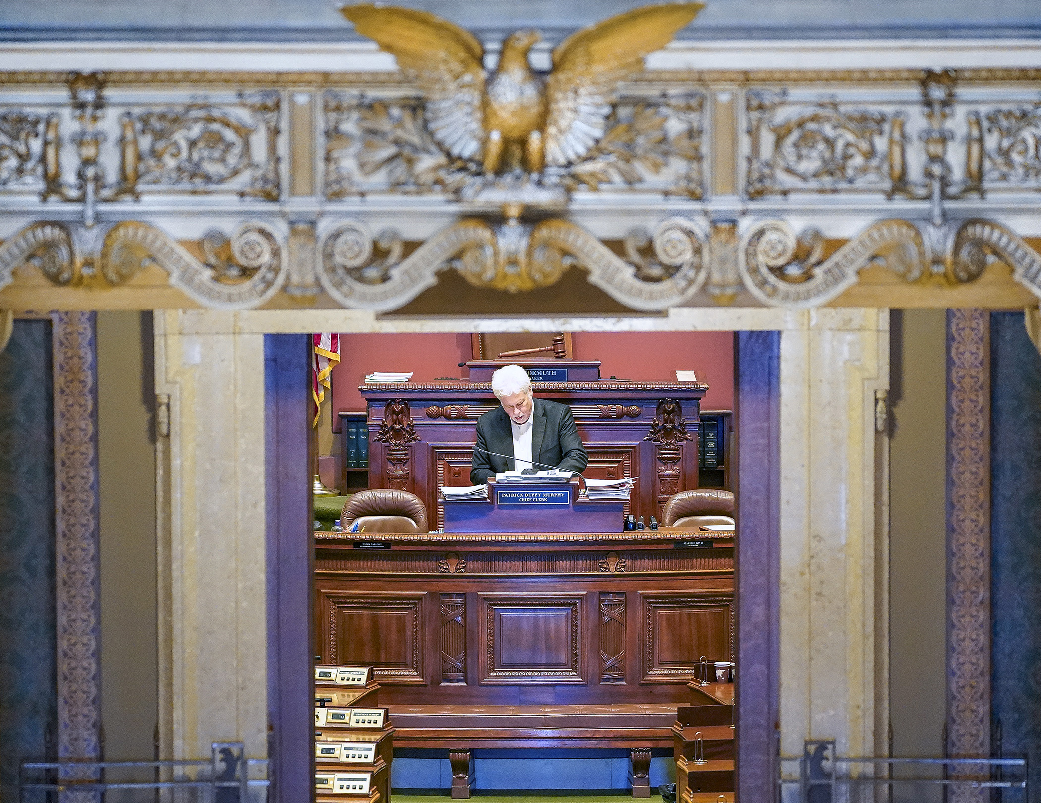 Chief Clerk Pat Murphy prepares for the Feb. 27 floor session at his desk in the House Chamber. (Photo by Andrew VonBank)